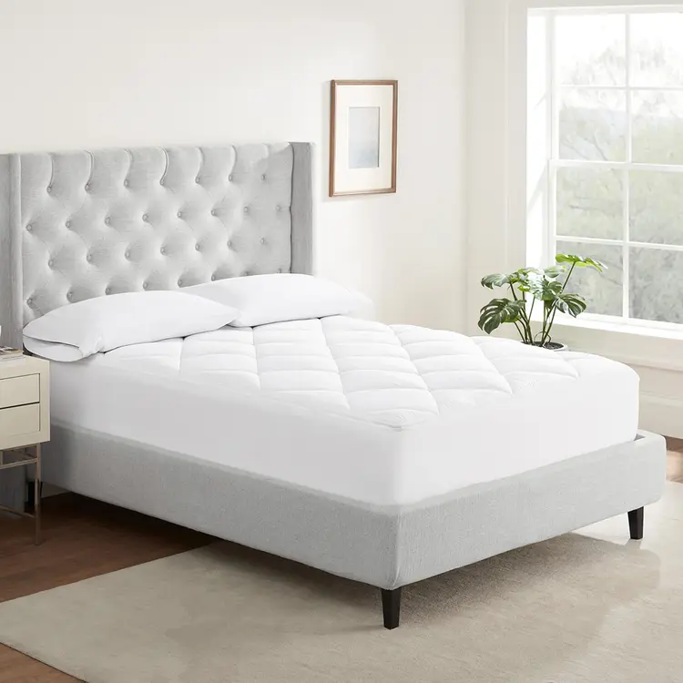 Serta Air Dry Extra Comfort Plus Mattress Pad on top of a mattress with 2 pillows on top.