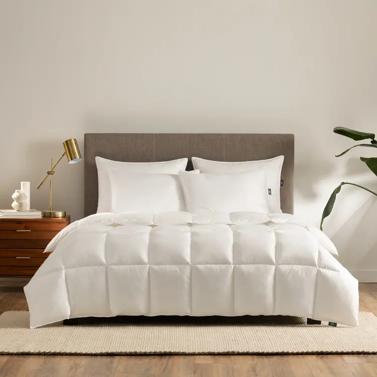 The Serta Light Down Illusion Down Alternative Comforter on a bed