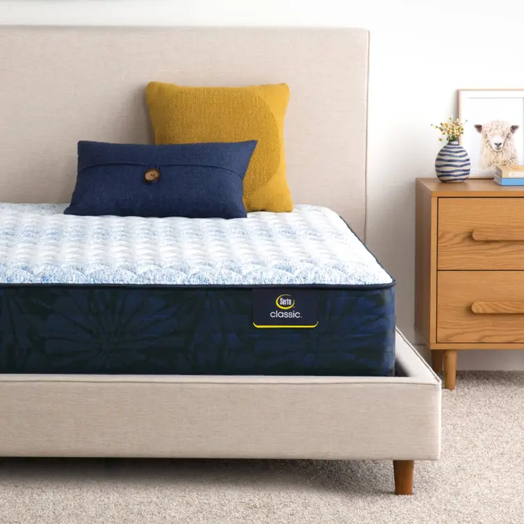 Serta classic alden medium mattress sitting in a beige bed frame ||feel: medium ||level: standard