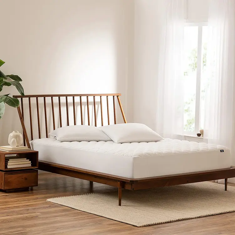The Serta Power Clean Waterproof Mattress Pad on a mattress in a bedroom